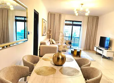 a living room with a table and some chairs at Yansoon 3 Downtown, Dubai in Dubai