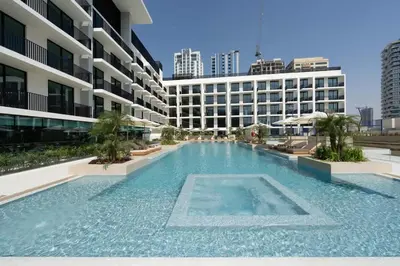 a large swimming pool in the middle of a building at Chic & Peaceful Studio Retreat Binghatti Aurora in Dubai