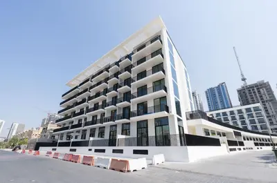 a large white building in the middle of a city at Chic & Peaceful Studio Retreat Binghatti Aurora in Dubai