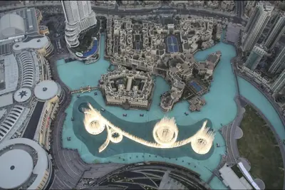 an aerial view of a city with buildings and water at BurjKhalifa l Live show fountain view 3BR Downtown in Dubai