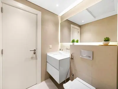 a bathroom with a white sink and a toilet at BurjKhalifa l Live show fountain view 3BR Downtown in Dubai
