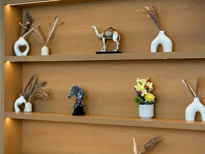 a shelf with a camel and other items on it at BurjKhalifa l Live show fountain view 3BR Downtown in Dubai