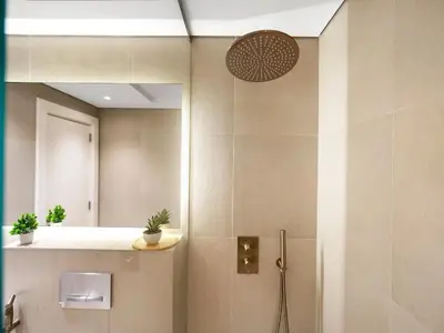 a bathroom with a shower with a mirror at BurjKhalifa l Live show fountain view 3BR Downtown in Dubai