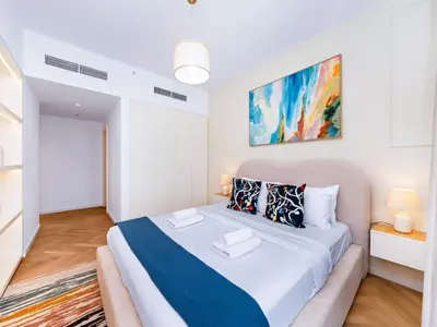 a white bedroom with a large bed in a room at BurjKhalifa l Live show fountain view 3BR Downtown in Dubai