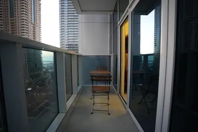 a balcony with a view of a city with tall buildings at Marina bedspace Partial Sea View close to Tram in Dubai