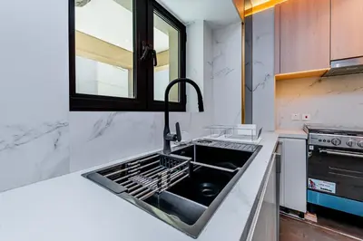 a kitchen with a sink and a stove at Escape24 Brand New Designer 2Bedroom with fully Burj Khalifa Views in Dubai