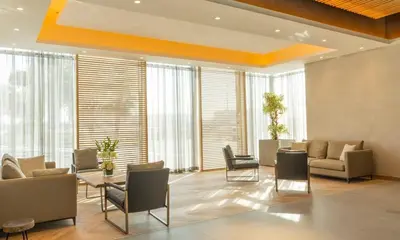a lobby with chairs and a couch and a table at Elegant Studio Apartment with Marina View JVT in Dubai