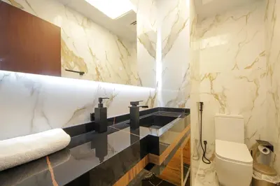 a bathroom with a white toilet and a sink at Silk Valley - Luxury 1BR | High Floor & Balcony | Sea Views in Dubai