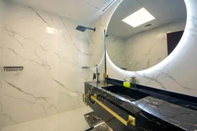 a bathroom with a sink and a mirror at Silk Valley - Luxury 1BR | High Floor & Balcony | Sea Views in Dubai