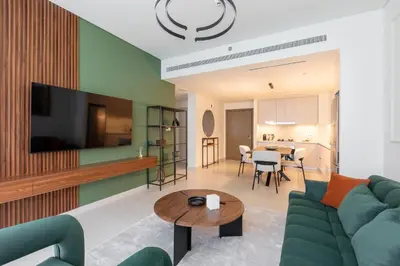 a living room with a couch and a table at Modern 1BR in Beach Mansion with Pool and Gym in Dubai