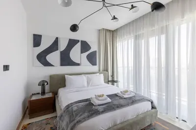 a bedroom with a bed with two towels on it at Vida Marina Residence High Floor Luxury 1 BR Flat in Dubai