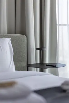 a bed with a table and a chair and a window at Vida Marina Residence High Floor Luxury 1 BR Flat in Dubai