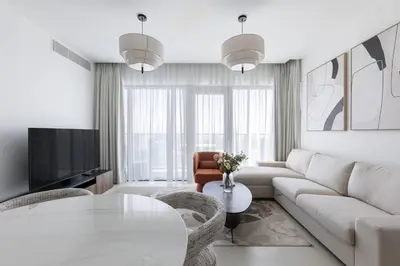 a living room with a white couch and a table at Vida Marina Residence High Floor Luxury 1 BR Flat in Dubai