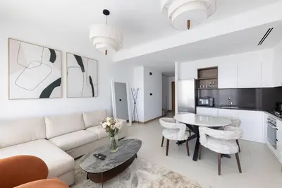 a living room with a white couch and a table at Vida Marina Residence High Floor Luxury 1 BR Flat in Dubai