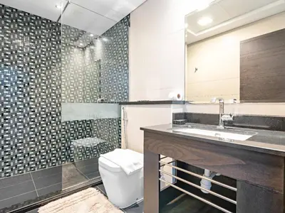 a bathroom with a sink and a toilet at Luxurious High Floor 1BDR With Full Sea View-Cayan48 in Dubai