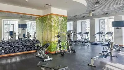 a gym with rows of exercise equipment in a room at Luxurious High Floor 1BDR With Full Sea View-Cayan48 in Dubai
