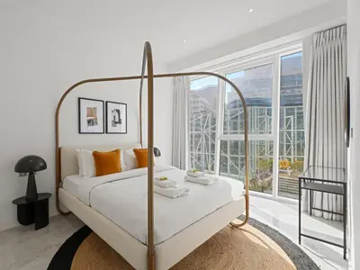 a bedroom with a bed and a large window at Stylish 1-Bedroom Escape The PAD Business Bay in Dubai