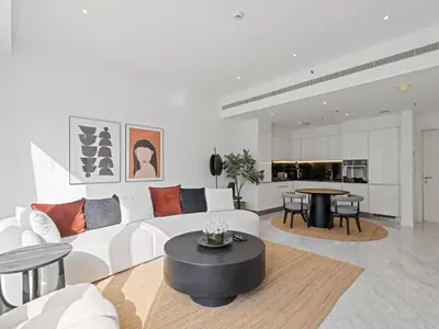 a living room with a white couch and a table at Stylish 1-Bedroom Escape The PAD Business Bay in Dubai