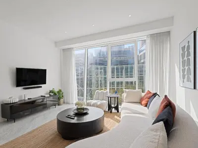 a living room with a white couch and a table at Stylish 1-Bedroom Escape The PAD Business Bay in Dubai