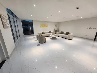 a large living room with couches and a table at 16 Studio in Skyz By Danube, Arjan in Dubai