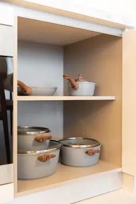 a kitchen shelf with bowls and worms in it at Spacious 1BR at Beach Mansion Balcony, Pool and Gym in Dubai