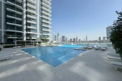a swimming pool in the middle of a building at Spacious 1BR at Beach Mansion Balcony, Pool and Gym in Dubai