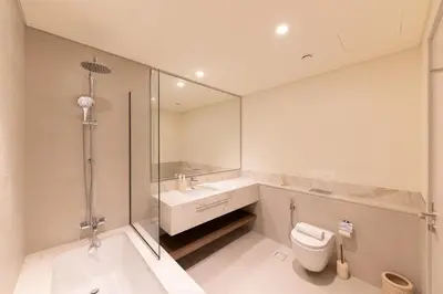 a bathroom with a toilet and a sink and a shower at Spacious 1BR at Beach Mansion Balcony, Pool and Gym in Dubai
