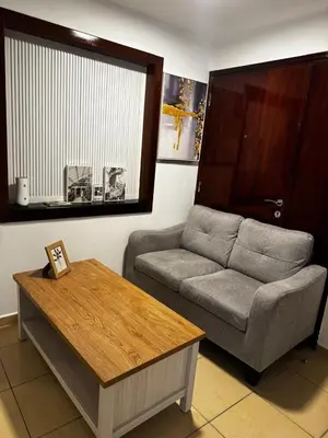 a living room with a couch and a table at Luxury cosy apartment in Dubai