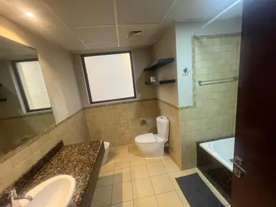 a bathroom with a sink and a toilet and a tub at Luxury cosy apartment in Dubai