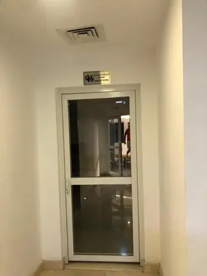 a door in a room with a sign above it at Beautiful newly renovated apartment in the heart of Dubai in Dubai
