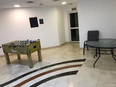 a room with a table and a table and a chessboard at Beautiful newly renovated apartment in the heart of Dubai in Dubai