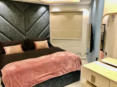 a bedroom with a large bed with a black headboard at Beautiful newly renovated apartment in the heart of Dubai in Dubai