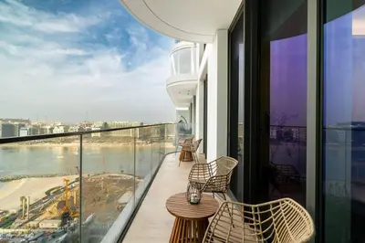 a balcony with chairs and a table on a building at CitiHome - Private Beach Access - Emaar Beachfront in Dubai