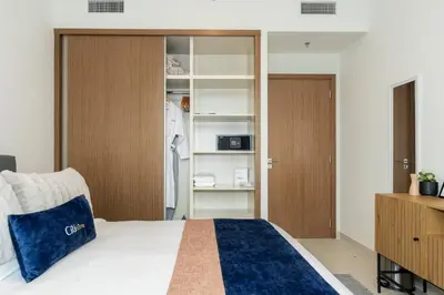 a bedroom with a bed and a book shelf at CitiHome - Private Beach Access - Emaar Beachfront in Dubai