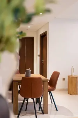 a table with two chairs and a coffee mug on it at CitiHome - Private Beach Access - Emaar Beachfront in Dubai