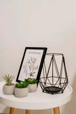 a white table with plants and a sign on it at CitiHome Elegant 2BR - Private Beach and Marina View in Dubai