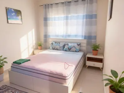 a bedroom with a bed in a room with plants at Luxury furnished bed room for VIP family in Dubai