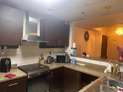 a kitchen with a sink and a stove top oven at Luxury furnished bed room for VIP family in Dubai