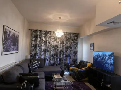 a living room with a couch and a tv at Luxury furnished bed room for VIP family in Dubai