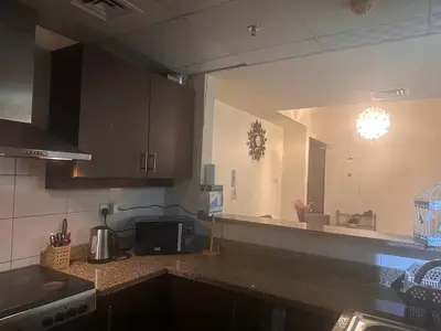 a kitchen with a counter top and a large mirror at Luxury furnished bed room for VIP family in Dubai