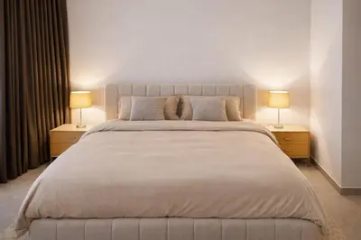 a bedroom with a large bed with two lamps at Stylish Brand New 2 bed Stay near Marina in Dubai