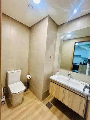 a bathroom with a toilet and a sink and a mirror at Modern brand new Loft Townhouse in Dubai in Dubai