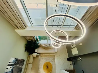 an overhead view of a lobby with a large chandelier at Modern brand new Loft Townhouse in Dubai in Dubai