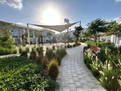 a pathway with a park with a slide and a playground at Modern brand new Loft Townhouse in Dubai in Dubai