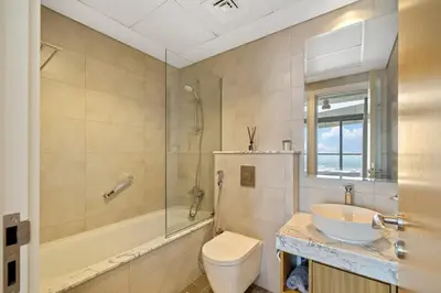 a bathroom with a toilet and a sink and a shower at DAMAC Aykon Tower - High-Floor Luxury 2-Bedroom Apartment in Dubai