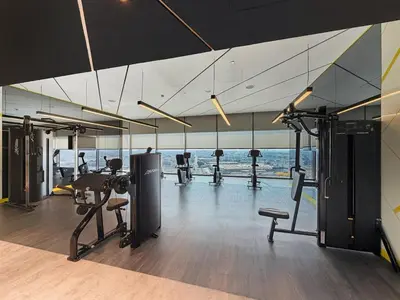 a gym with treadmills and cardio equipment in a building at DAMAC Aykon Tower - High-Floor Luxury 2-Bedroom Apartment in Dubai