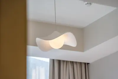a light fixture hanging from a ceiling at DAMAC Aykon Tower - High-Floor Luxury 2-Bedroom Apartment in Dubai