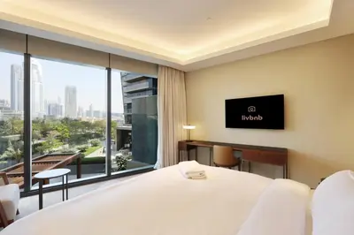 a hotel room with a large bed and a large window at 3B in Downtown with Burj Khalifa View Near Dubai Mall and Opera District in Dubai