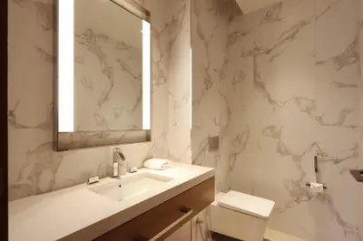 a bathroom with a sink and a mirror and a toilet at 3B in Downtown with Burj Khalifa View Near Dubai Mall and Opera District in Dubai