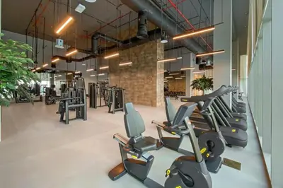 a gym with rows of exercise bikes and treadmills at 3B in Downtown with Burj Khalifa View Near Dubai Mall and Opera District in Dubai